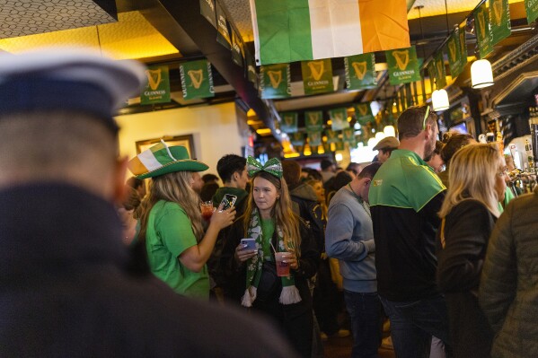 FILE - People enjoy drinks in a local Irish pub during the St. Patrick's Day, Thursday, March 17, 2022, in New York. (AP Photo/Eduardo Munoz Alvarez, File)