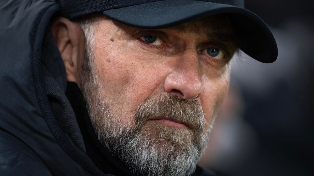 Close up portrait image of Liverpool manager Jurgen Klopp who is wearing a black cap.