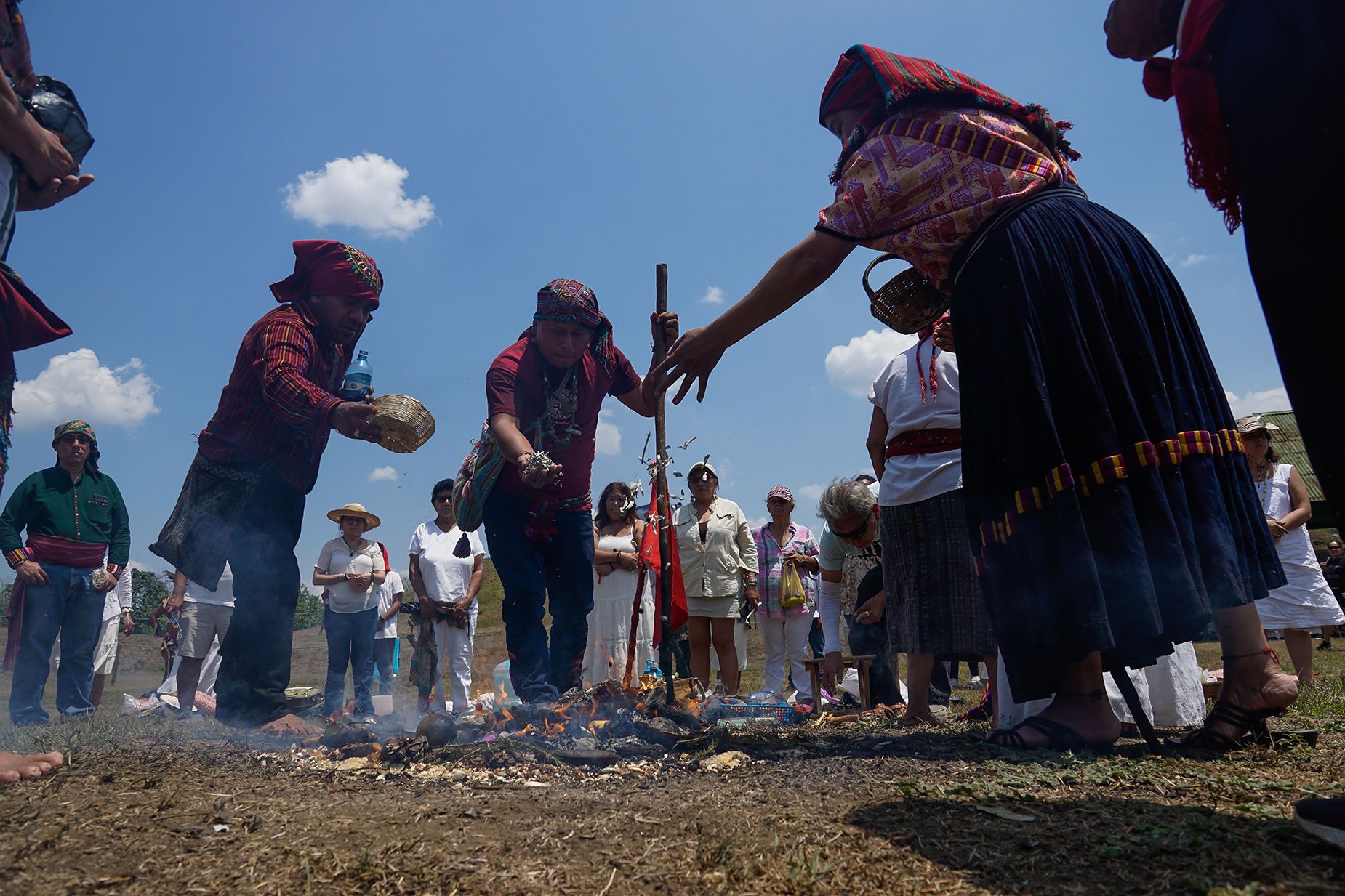 Salvadoran indigenous people deliver offerings to the fire during the celebration of the spring equinox 2023 at the archaeological site of San Andrés in the Zapotitán Valley of El Salvador.