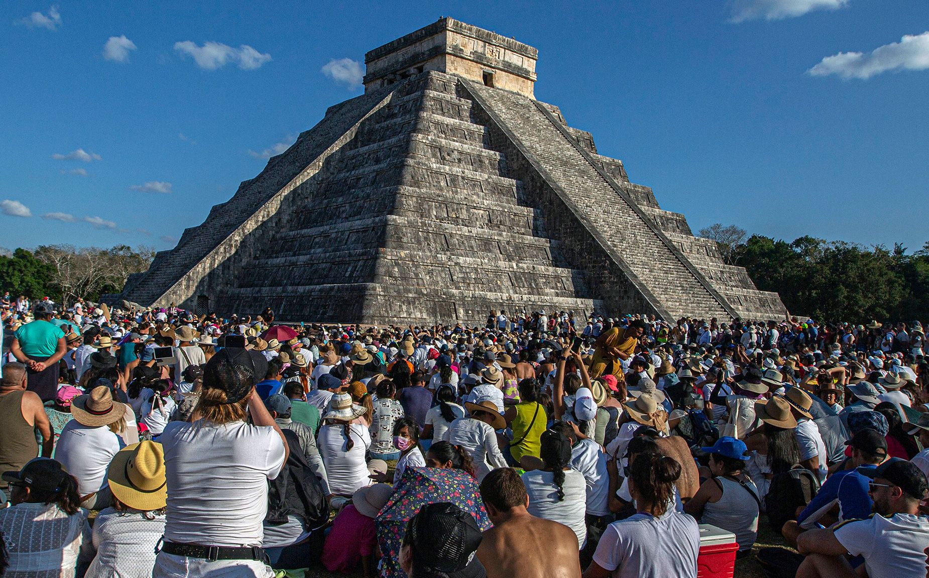 People surround the Kukulcan Pyramid at the Mayan archaeological site of Chichén Itzá in Yucatan State, Mexico, during the celebration of the spring equinox in 2023.