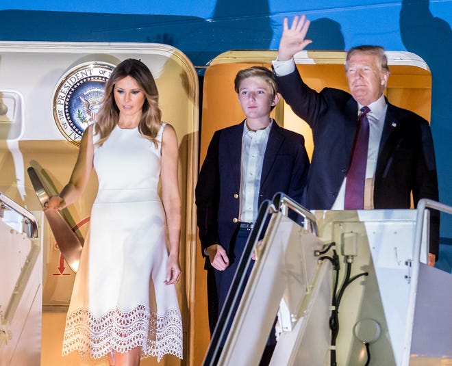President Donald Trump, first lady Melania, and their son Barron arrive on Air Force One at Palm Beach International Airport on November 21, 2018.