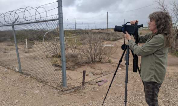 Sharon Wilson of Oilfield Witness sets up her Optical Gas Imaging camera outside a ONEOK compressor station near the Waha Hub in Pecos County, Texas on March 16. Credit: Martha Pskowski/Inside Climate News