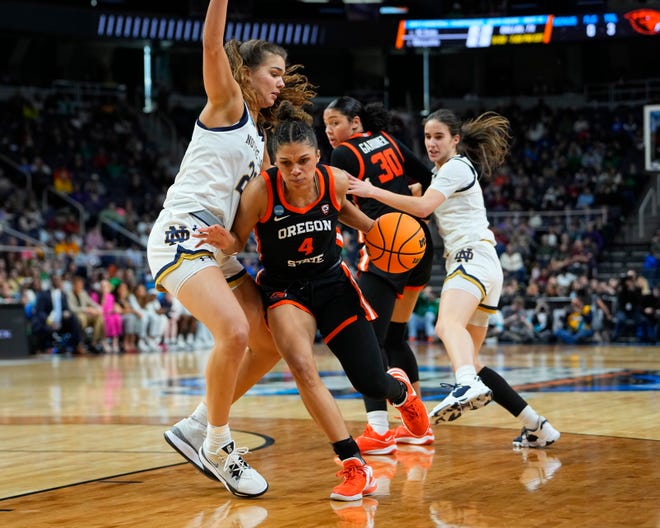 Oregon State Beavers guard Donovyn Hunter (4) dribbles the ball against Notre Dame Fighting Irish forward Maddy Westbeld (21) during the second half in the semifinals of the Albany Regional of the 2024 NCAA Tournament at the MVP Arena March 29, 2024, in Albany, New York.