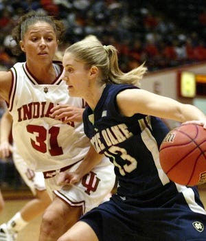 Notre Dame's Megan Duffy, front, drives on Indiana's Leah Enterline during the first half Wednesday in Bloomington, Ind..