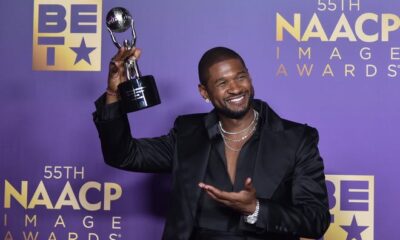 Usher poses with his entertainer of the year trophy during the 55th annual NAACP Image Awards on March 16, 2024.