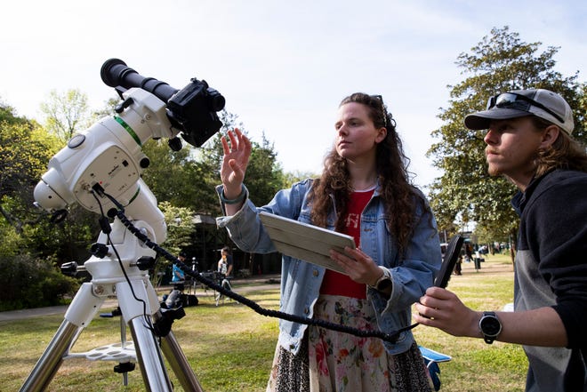 Faith Kjosa and Dustin Roberts set up their camera with a star tracker used for astrophotography to photograph the total solar eclipse on Arlington Lawn at Hot Springs National Park in Hot Springs, Arkansas, on April 8, 2024.