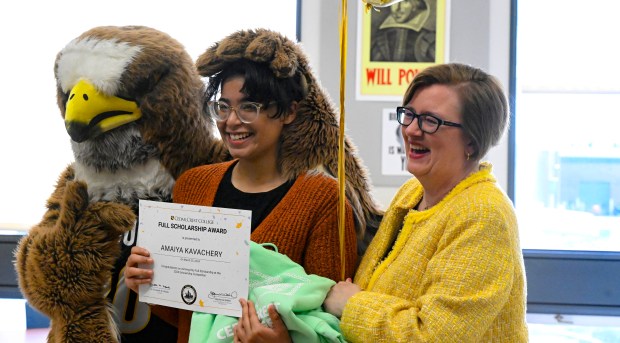 Amaiya Kavachery, a student at Lehigh Career Technical Institute, stands with Frank the Falcon and Elizabeth Meade, president of Cedar Crest College. Kavachery is awarded a full-tuition scholarship to Cedar Crest College Tuesday, April 9, 2024, at LCTI in North Whitehall Township. She was the winner of the college's annual scholarship competition, and was presented with her full-tuition prize, flowers and an appearance from Franki the Falcon. (Monica Cabrera/The Morning Call)