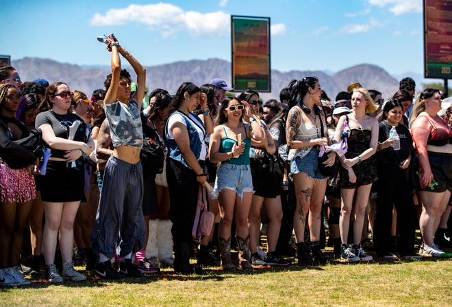 Festivalgoers wait at the main entrance gate for the grounds to be opened during the Coachella Valley Music and Arts Festival in Indio, Calif., Friday, April 12, 2024.