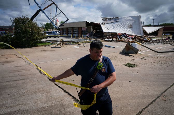 Firefighter Jeremy Perez works the scene where a tornado damaged several businesses in Katy, Texas, on Wednesday, April 10. Dangerous storms moved through parts of the southeast this week, spawning tornadoes and flash flood emergencies.