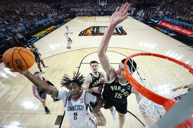 UConn guard Tristen Newton attempts a layup over Purdue's Zach Edey during the NCAA men's basketball national championship game on Monday, April 8, in Phoenix, Arizona. UConn defeated Purdue 75-60 to win its second consecutive title, becoming the first back-to-back champion since Florida in 2006 and 2007.