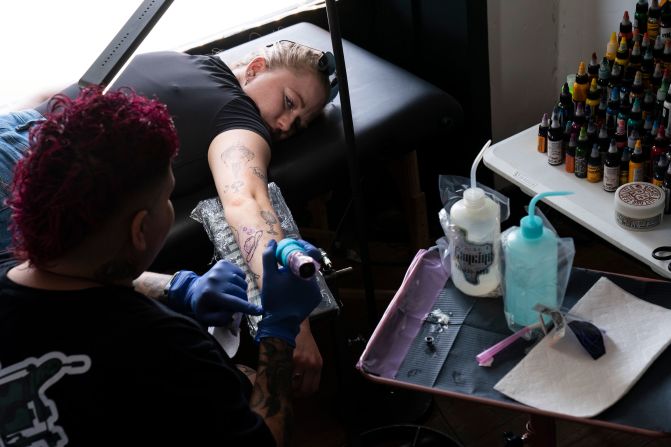 Gwen Rychlik gets a tattoo of a moon and cowboy hat at a popup tattoo parlor in Del Rio, Texas, on Saturday, April 6. Eclipse lovers from far and wide gathered in South Texas earlier this week to get a view of the total solar eclipse.