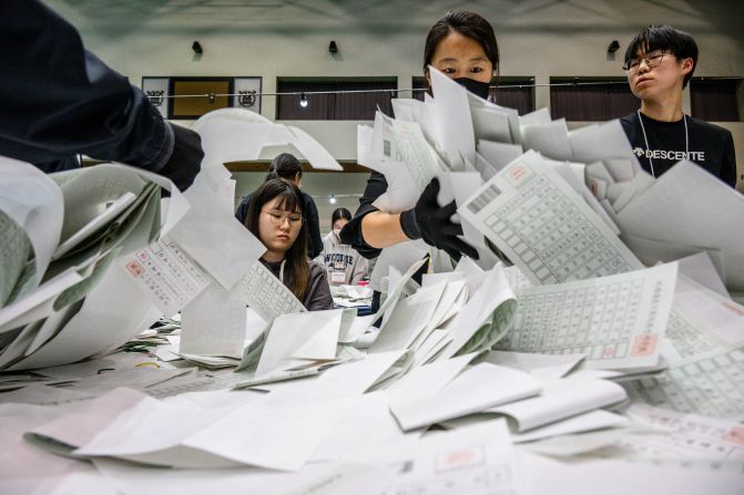 Election officials sort through ballots at a counting station in Seoul, South Korea, after voting closed on Wednesday, April 10. South Korea's liberal opposition parties scored a landslide victory in the parliamentary election.