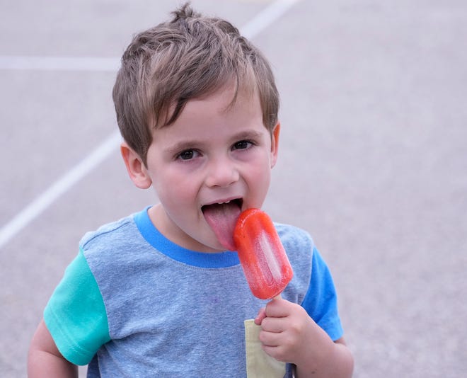 Tate Walker, 3, who was with his mother, Megan, a disegner with Eppstein Uhen Architects, eats a Pete’s Pop popsicle during the Fox Point-Bayside School District groundbreaking for the construction of the new Bayside Middle School on East Ellsworth Lane in Bayside on Thursday, July 13, 2023.