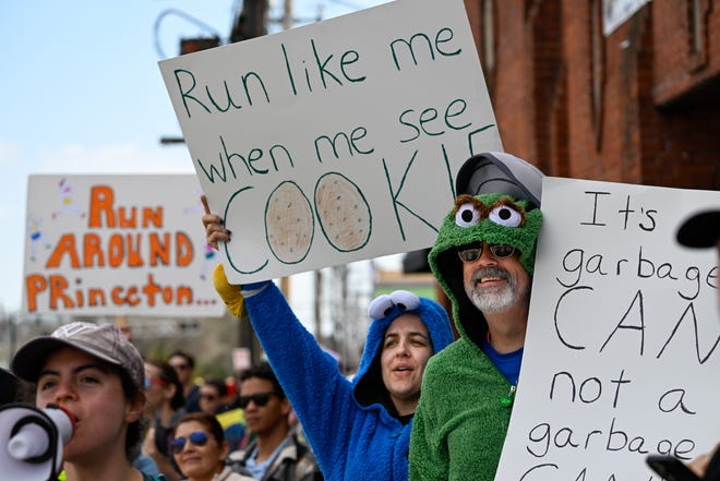 Stephanie Melka and Jim Purvis, both of New York, dressed in costume as they cheer on runners during the 128th running of the Boston Marathon in Framingham, April 15, 2024.