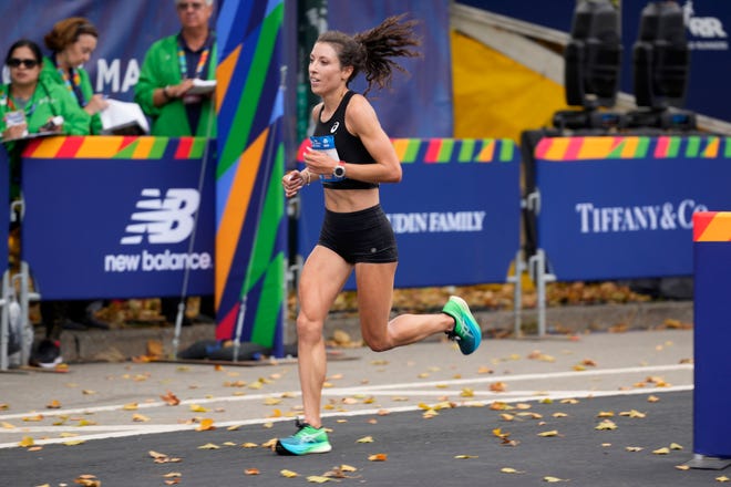 Nov 6, 2022; NYC, NY, USA;  Emma Bates gets ready to cross the finish line, with a time of 2:26:53. Bates was the second American woman to cross the line in Central Park, Sunday, November 6, 2022.  Mandatory Credit: Kevin Wexler-The Record