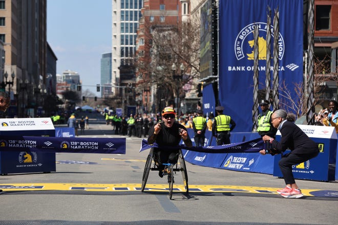 Eden Rainbow Cooper of Great Britain crosses the finish line to win the Professional Women's Wheelchair Division at the 128th Boston Marathon on April 15, 2024, in Boston, Massachusetts.
