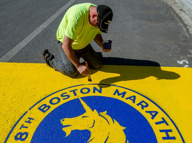 Pete Thibeault paints the start line for the 128th running of the Boston Marathon, which is celebrating its 100th start from Hopkinton, April 9, 2024.