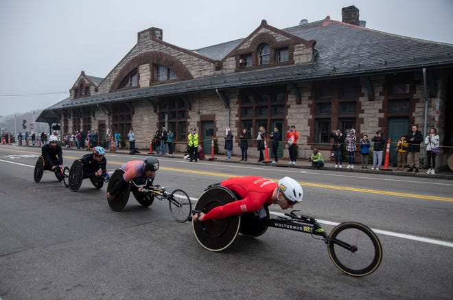 Jetze Plat leads fellow wheelchair racers during the 127th running of the Boston Marathon on Waverly Street in Framingham, April 17, 2023.
