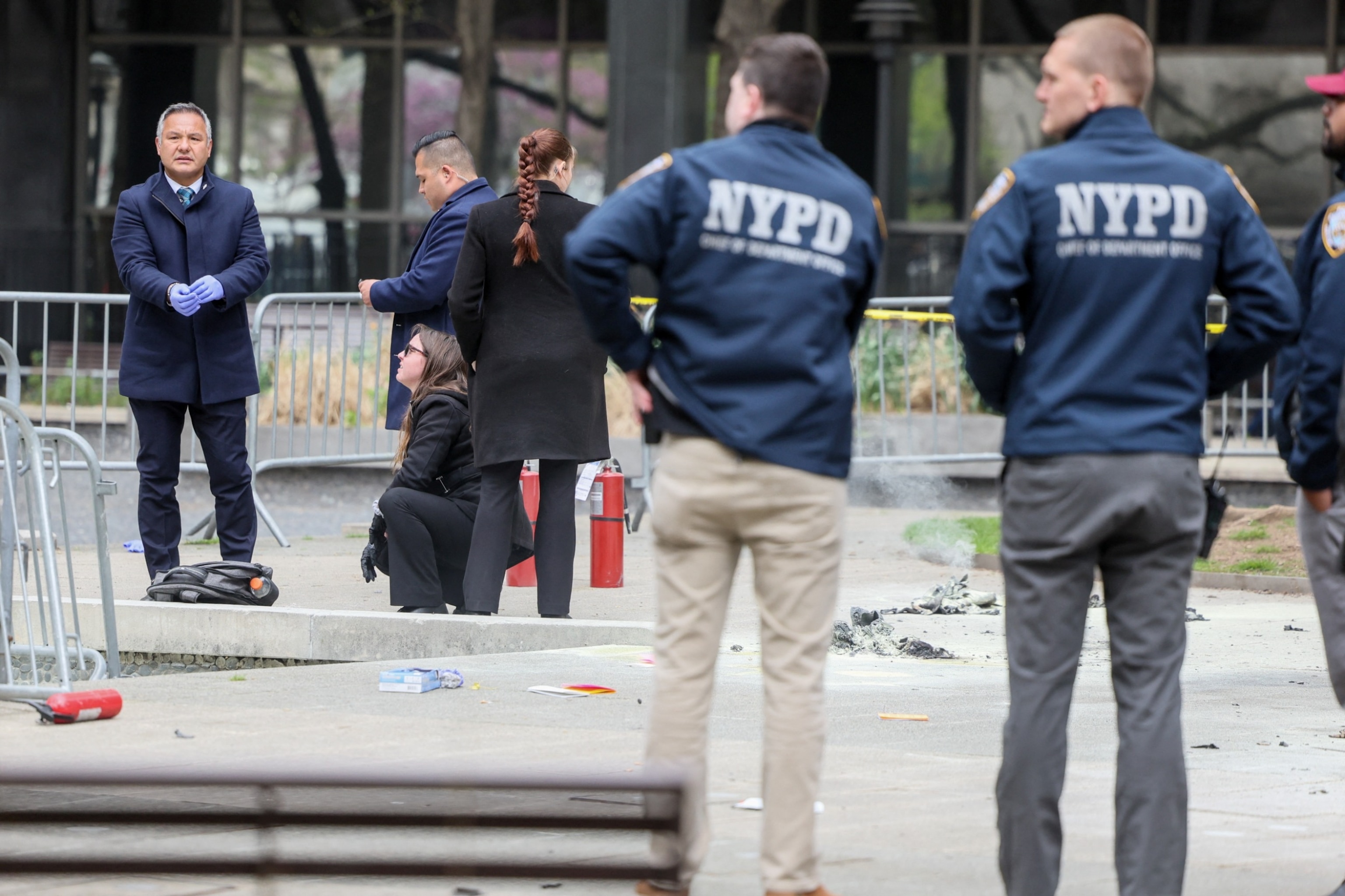 PHOTO:  Emergency personnel respond to a report of a person covered in flames, outside the courthouse where former President Donald Trump's criminal hush money trial is underway, in New York, April 19, 2024.
