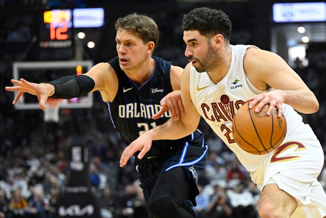 Apr 20, 2024; Cleveland, Ohio, USA; Orlando Magic center Moritz Wagner (21) defends Cleveland Cavaliers forward Georges Niang (20) in the second quarter during game one of the first round for the 2024 NBA playoffs at Rocket Mortgage FieldHouse. Mandatory Credit: David Richard-USA TODAY Sports