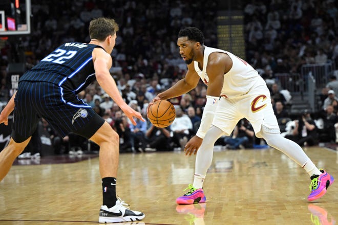 Cleveland Cavaliers guard Donovan Mitchell (45) dribbles against Orlando Magic forward Franz Wagner (22) in the second quarter during Game 1 of a 2024 NBA first-round playoff series Saturday in Cleveland.