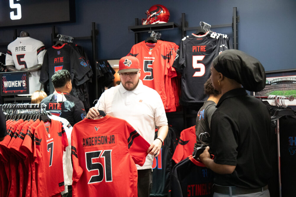 Houston Texans fans browse through the NRG fan shop in search for the perfect swag ahead of the season as the team unveils their new uniform on April 23, 2024. (Photo Credit: Daisy Espinoza / Houston Public Media)
