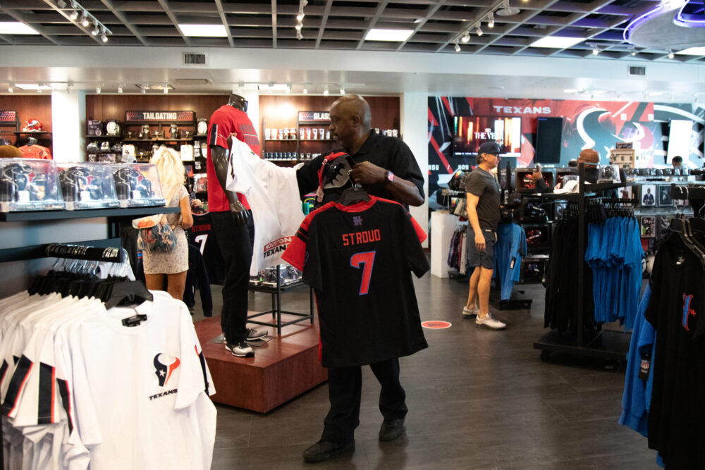 Houston Texans fans browse through the NRG fan shop in search for the perfect swag ahead of the season as the team unveils their new uniform on April 23, 2024. (Photo Credit: Daisy Espinoza / Houston Public Media)