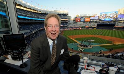 John Sterling sits in his booth before a baseball game against the Boston Red Sox at Yankee Stadium in New York on Sept. 25, 2009.
