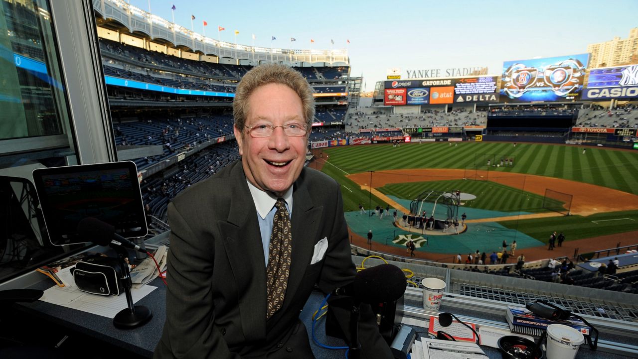 John Sterling sits in his booth before a baseball game against the Boston Red Sox at Yankee Stadium in New York on Sept. 25, 2009.