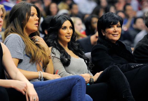Khloe Kardashian, left, sits with her sister Kim Kardashian, center, and her mother Kris Jenner as they watch the Los Angeles Clippers play the Dallas Mavericks in their NBA basketball game, Wednesday, Jan. 18, 2012, in Los Angeles.