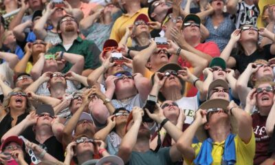 People watch the solar eclipse at Saluki Stadium on the campus of Southern Illinois University on August 21, 2017 in Carbondale, Ill.