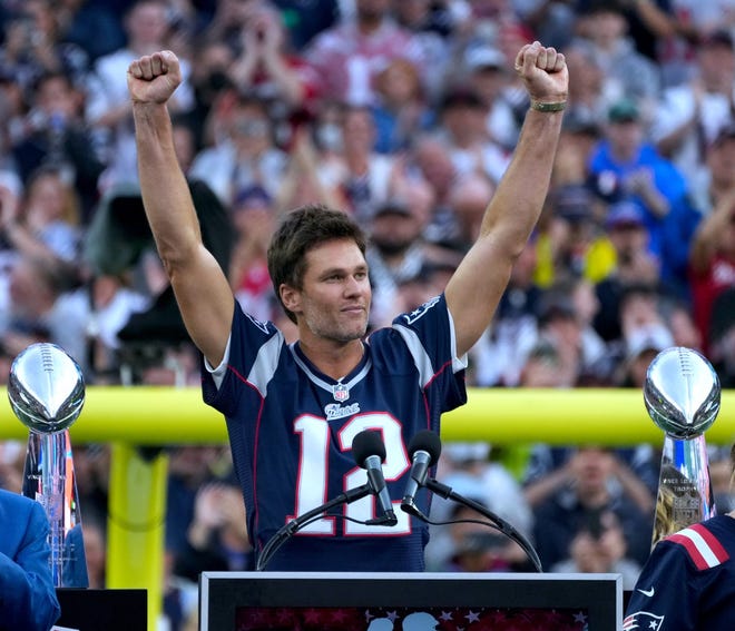 Tom Brady acknowledges his fans during a halftime celebration and the announcement of his induction in the the Patriots Hall of Fame.