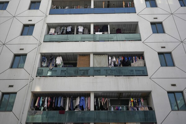 Clothes dry on balconies of a residential building in Dubai, United Arab Emirates, Friday, July 4, 2025. (AP Photo/Altaf Qadri)