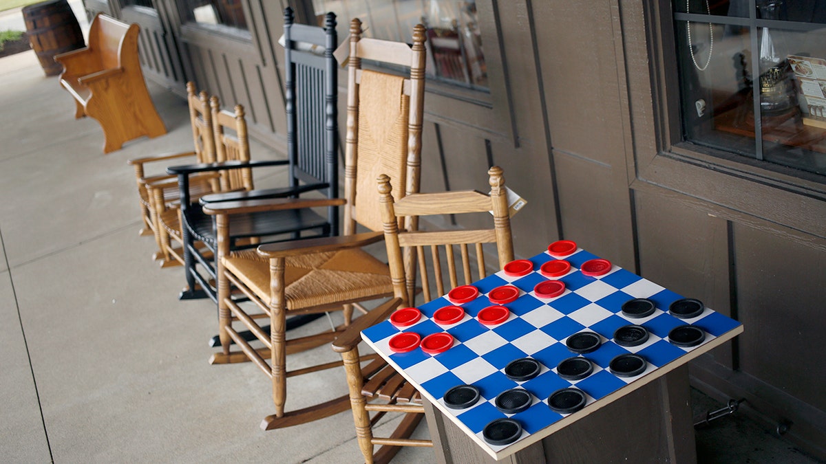 Rocking chairs and a checkers board are for sale outside a Cracker Barrel Old Country Store restaurant.