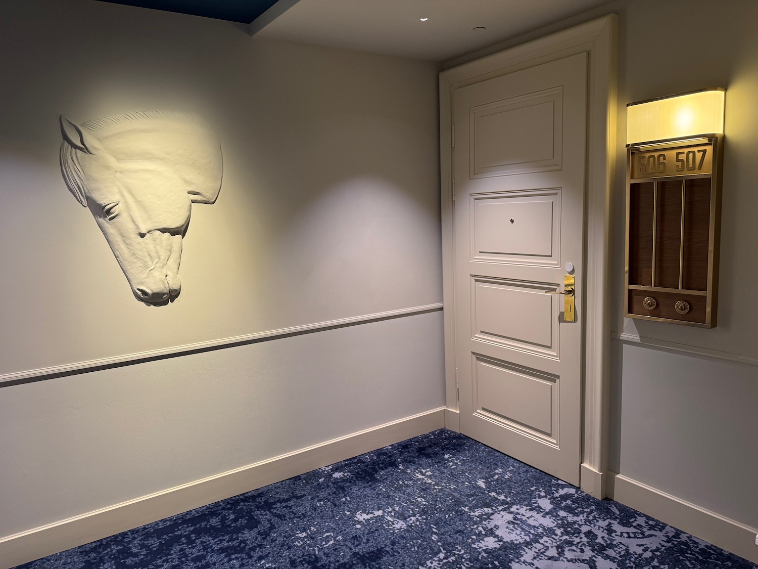 a room with a door and a horse head on the wall