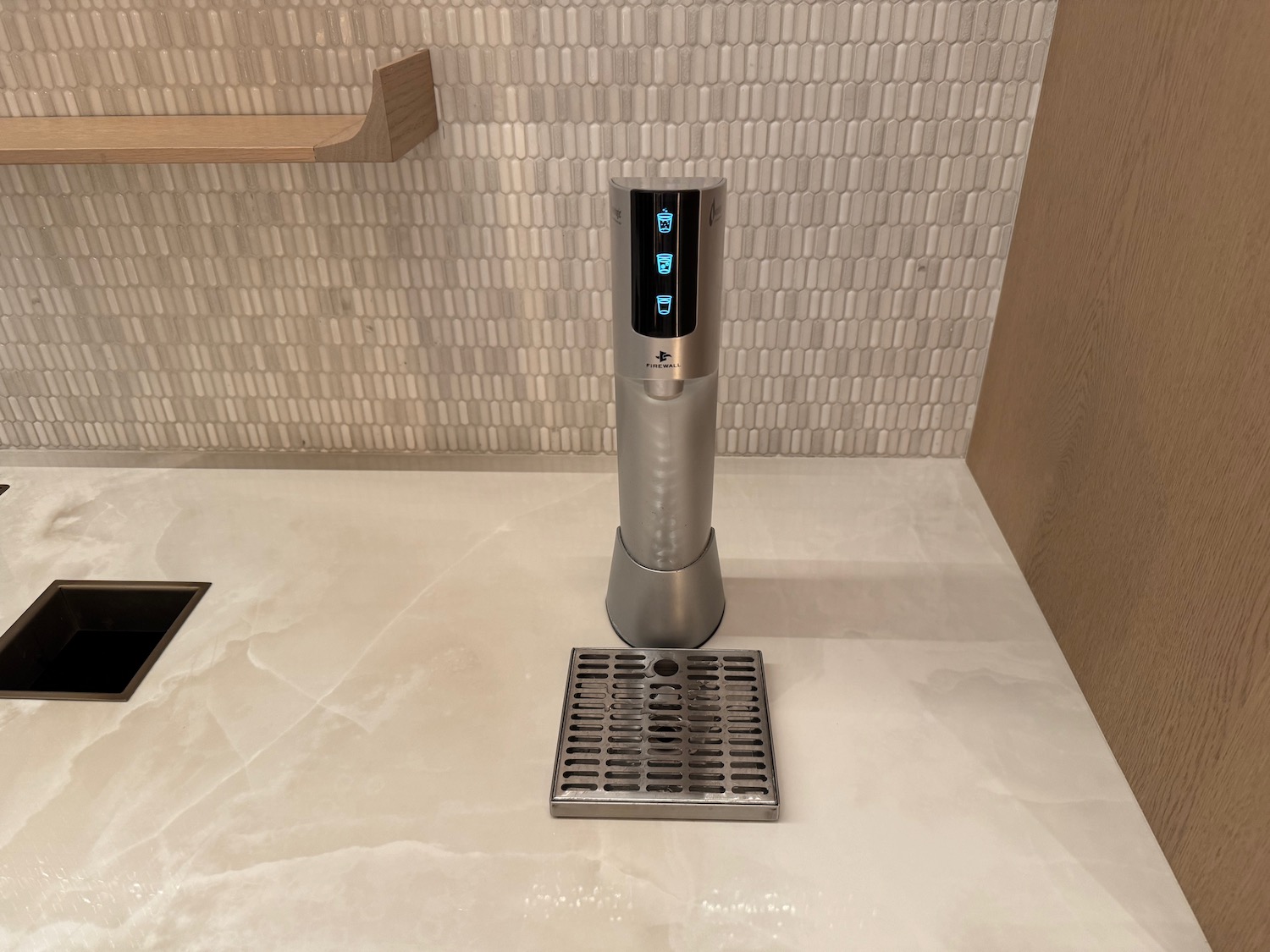 a silver and black device on a white tile floor