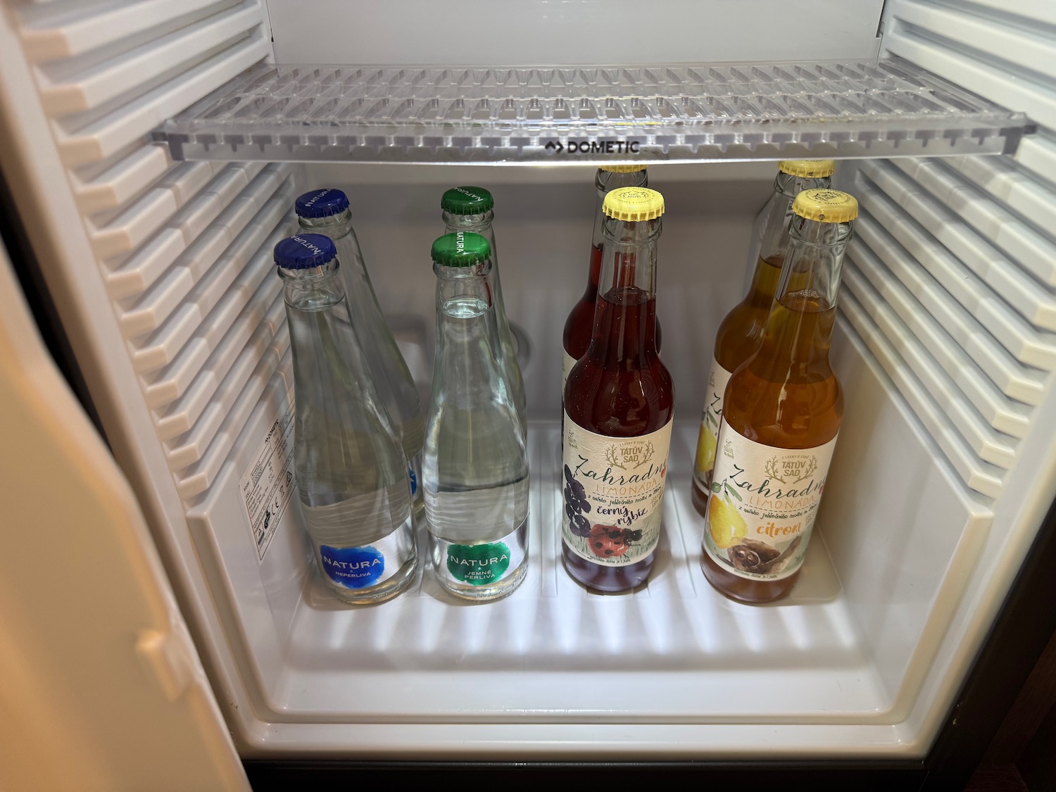 a refrigerator with bottles of liquid