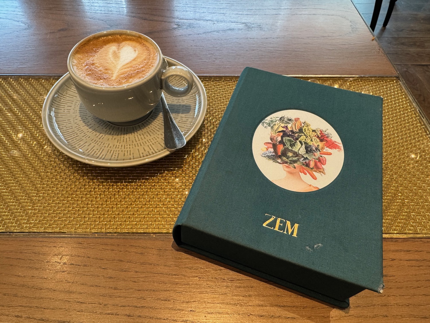 a coffee cup and a book on a table