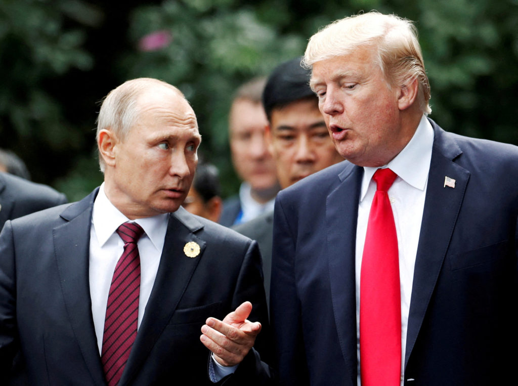 FILE PHOTO: U.S. President Donald Trump and Russia's President Vladimir Putin talk during the family photo session at the ...