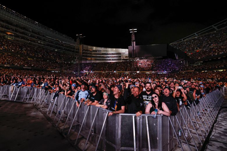Fans in Chicago watch the band on Thursday night.
