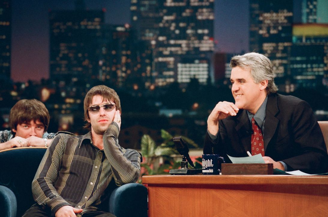 Liam, with Noel over his shoulder, during a 1998 appearance on