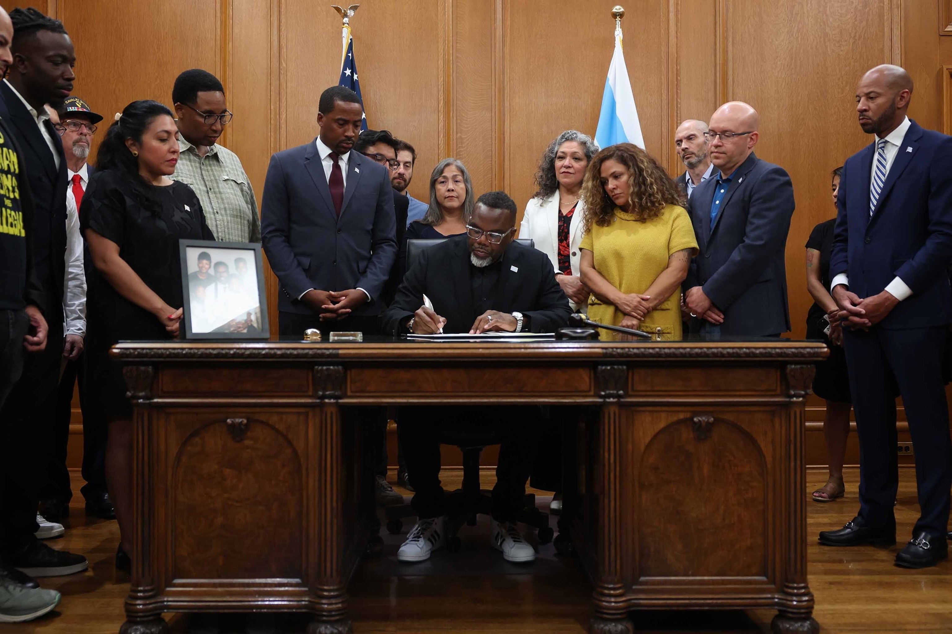 Mayor Brandon Johnson signs an executive order titled