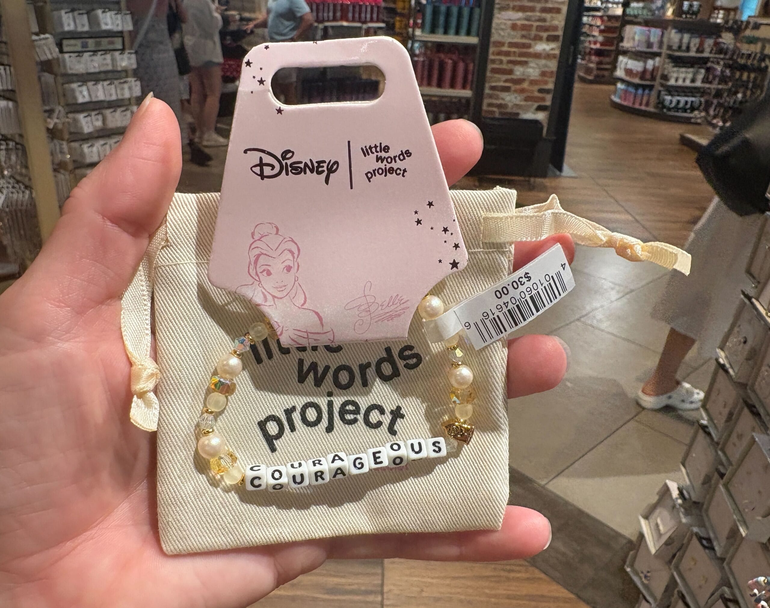 A hand holds a Disney