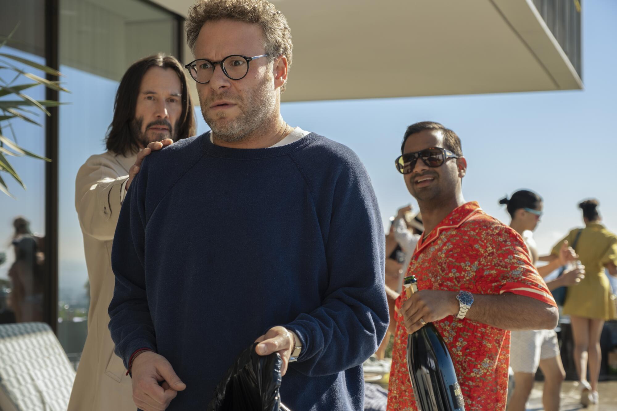 Three men hatch a plan on a Los Angeles porch.