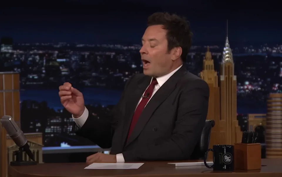 Jimmy, mid-sentence, gesturing with hand on his talk show