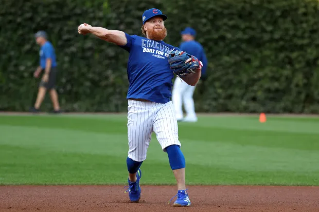 Cub Justin Turner throws a ball during practice at Wrigley...