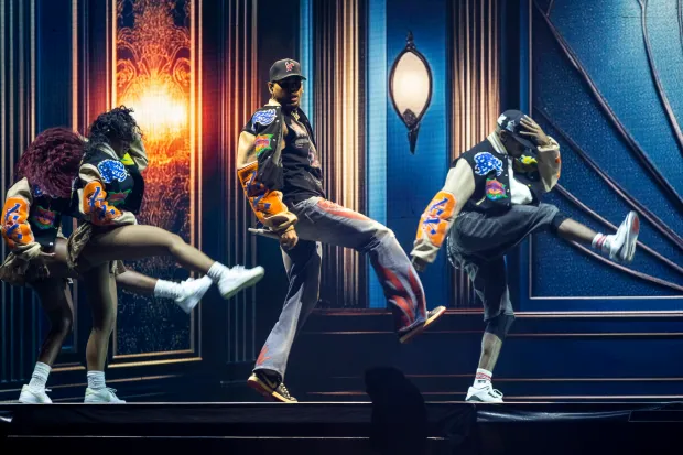 Chris Brown moves and sings while flanked by his dancers...