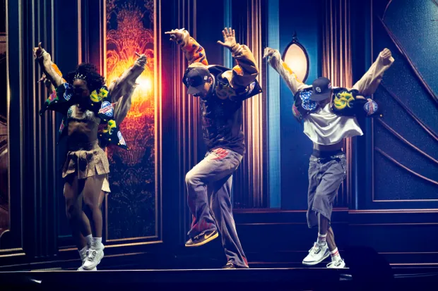 Chris Brown moves and sings while flanked by his dancers...